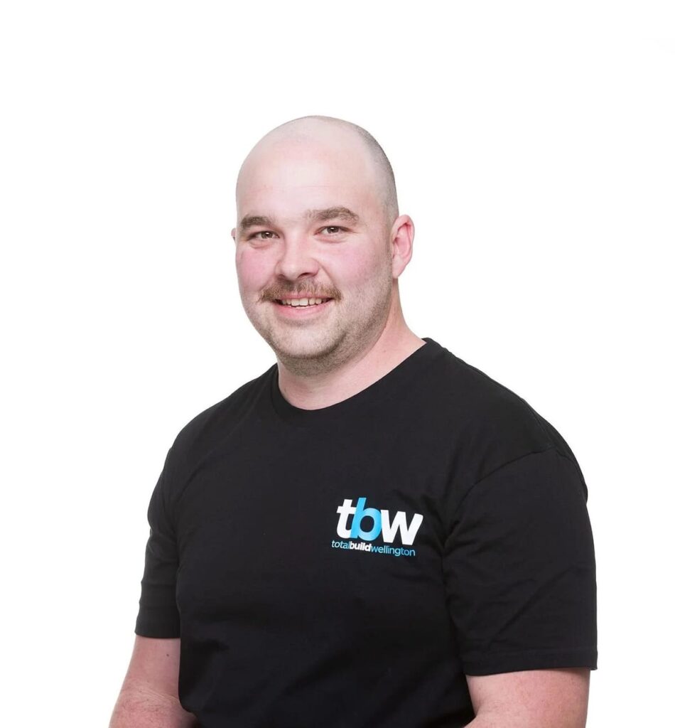 A member of a professional building team wearing branded workwear, representing a home builder experienced in project managment, home construction, and design and build services for new builds including 2 bedroom house design and three bedroom house design options.